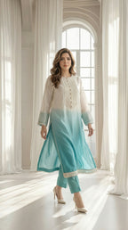 Woman wearing ivory to aqua ombre embroidered kurta set with matching trousers and pearl detailing
