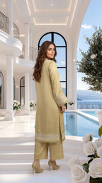 Woman in a light green traditional outfit standing by a pool with a scenic background