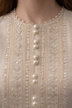 Close-up of a beaded and embroidered garment with pearls