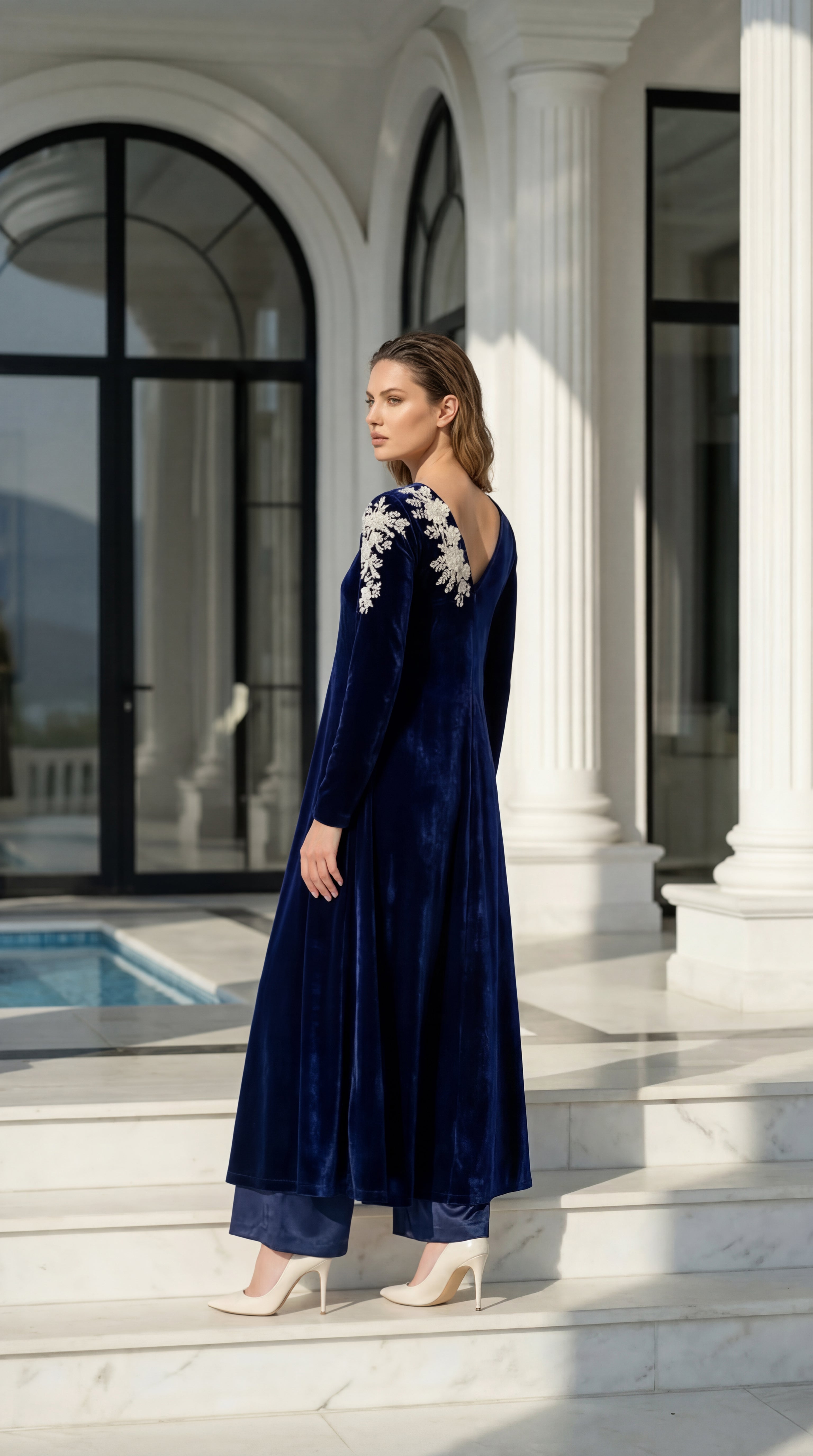 Women’s festive velvet dress featuring embroidered shoulders and open back detail